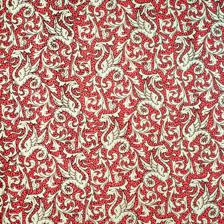 Flourish pattern wallpaper. Mythical creature pattern on dotted red background.
