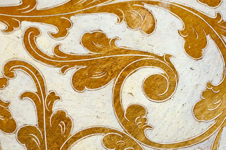 Fourish pattern. Gold leaf floral design on white background. Old, antique surface.の写真素材