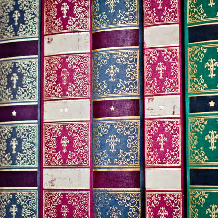 Collection of old, aged books in a row. Leather hardcover manuscripts.の写真素材