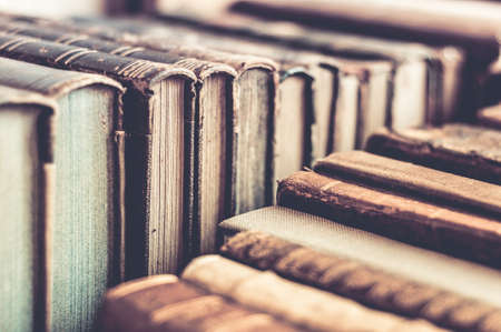 Old books background. Row of old leather covered books. Aged, used books.の写真素材