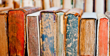 Collection of old, aged books in a row. Leather hardcover manuscripts.の写真素材