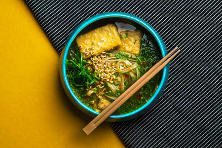 Top angle view of tasty bowl of noodles with chopsticksの写真素材