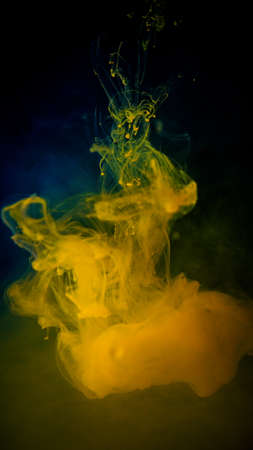 Color drop in water on black backgroundの写真素材