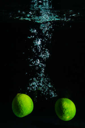 Green Lime in Water on Black Backgroundの写真素材