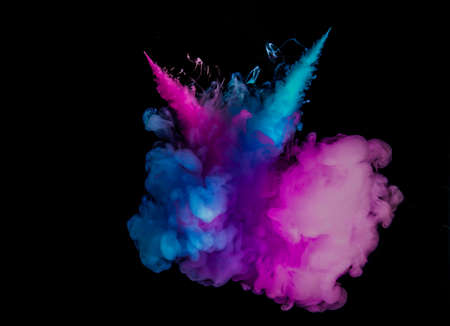 Color drop in water on black backgroundの写真素材