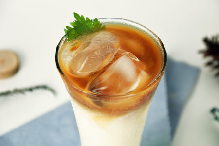 Closeup photo of white, brown and green pandan milk iced coffee that looks very fresh on an isolated...