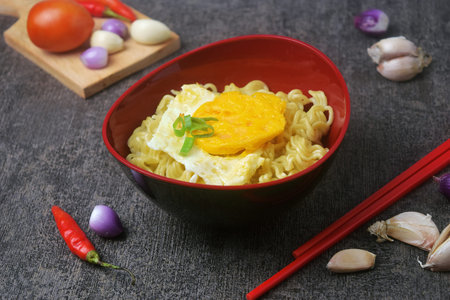 Closeup photo of a bowl of boiled noodles with fried egg that looks very delicious on a very elegant...