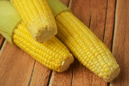 Closeup shot of some peeled corn on a wooden table and will be used to make soup