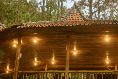 Javanese house style wooden ceilings with lamps are at the Guci Forest tourist attraction