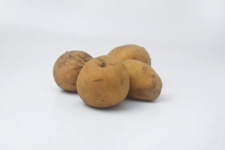 Closeup photo of several raw potatoes on an isolated white backgroundの写真素材