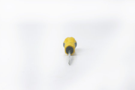 Closeup photo of A yellow screwdriver is on an isolated white backgroundの写真素材