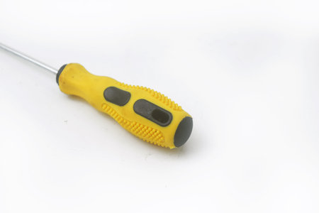 Photo of A yellow screwdriver is on an isolated white backgroundの写真素材