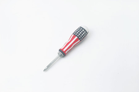 Photo seen from above of a screwdriver patterned with the colors of the American flag on an isolated white backgroundの写真素材