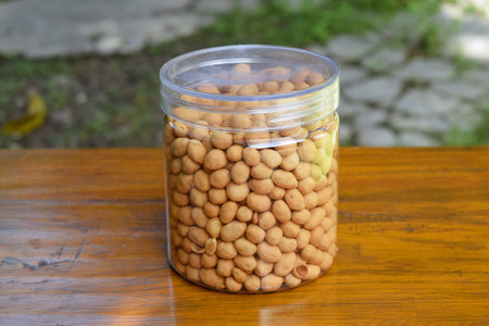 Dried beans in food storage or jar with beautiful green garden background