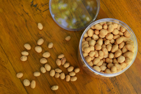 Top view of some dried Nuts and food storage or jars on wooden table backgroundの写真素材