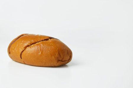 Closeup photo of brown bread on white backgroundの写真素材
