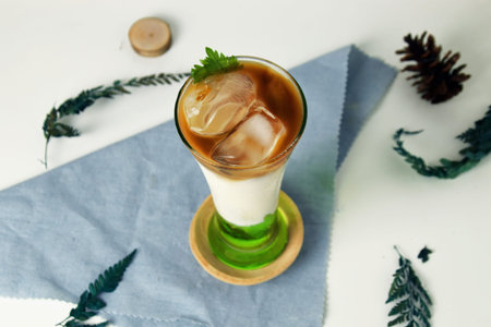Pandan Iced Coffee with a blend of milk, coffee, and pandan syrup on an isolated white background