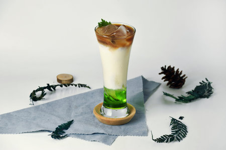 Pandan Iced Coffee with a blend of milk, coffee, pandan and melon syrup on an isolated white...