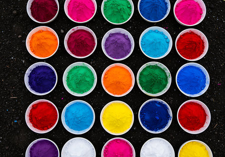 A top-down view of numerous small, white bowls filled with colorful powder dyes. Generative Aiの素材