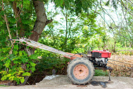 A motor machine of tractor for farmer. Tractor is common for used to describe a farm vehicle that provides the power and traction to mechanize agricultural tasks. Tractor speed is slow speeds.の写真素材