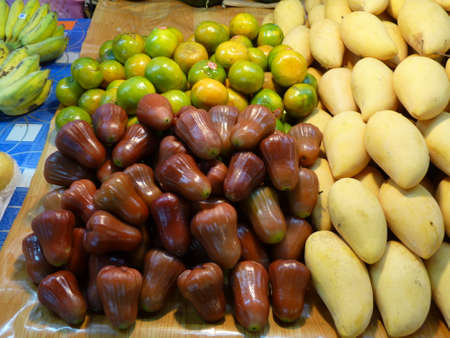 Asian food market, exotic fruits rose apple, mango and mandarinの写真素材