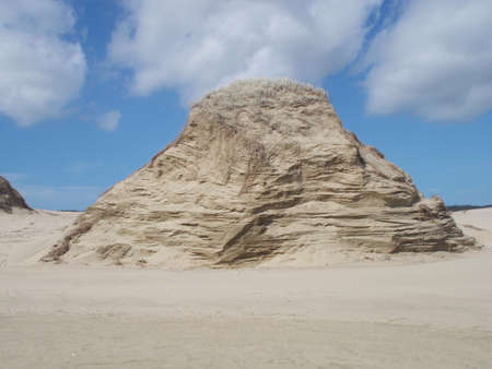 Sand Dune formation at Ninety mile Beach with clouds in the sky on North Island in New Zealandの写真素材
