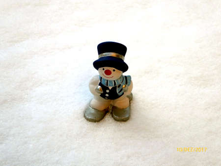 Snow background with a ceramic skiing snowman in Germanyの写真素材
