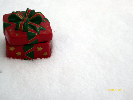 Christmas parcel present with bow on white snow background