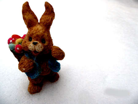 Easter bunny in the snow with copy space for text happy easter in gardenの写真素材