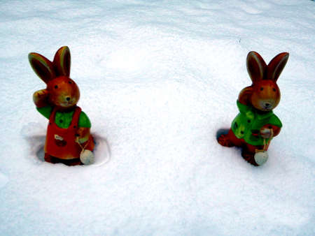 Easter bunny in the snow with copy space for text happy easter in gardenの写真素材