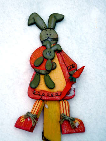 Easter bunny in the snow with copy space for text happy easter in gardenの写真素材