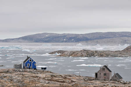 Two small houses in settlement with ice in backgroundの写真素材