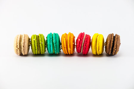 Seven sweet colorful french macarons or macaroons on white backgroundの写真素材