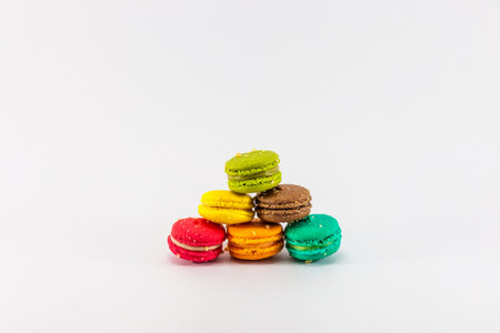 Six sweet colorful french macarons or macaroons on white backgroundの写真素材