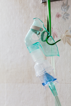 Close-up image of an oxygen mask hangingの写真素材