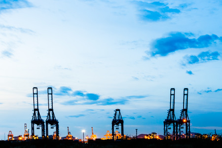 crane at trade port with blue sky in twilightの写真素材