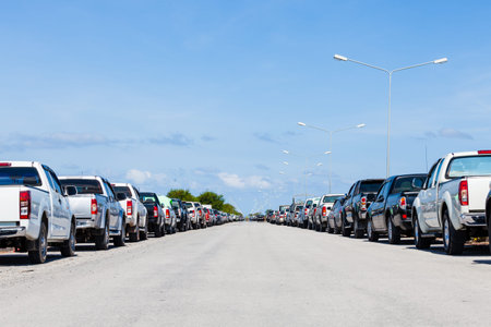 row of parked cars in parking lot