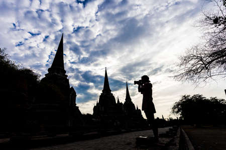 Silhouette of Traveler take a picture of Ayutthaya Old Town filled with historic sites, Ayutthaya Historical Park, Thailandの写真素材