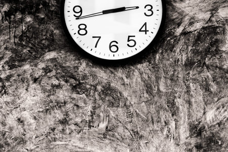 Part of clock on polished plaster wallの写真素材