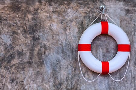 Life buoy hanging on polished plaster wallsの写真素材