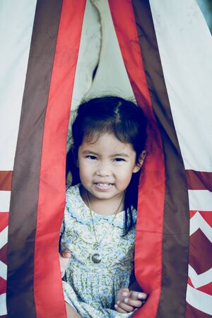 Close Up of asian little girl with wigwam Indiansの写真素材