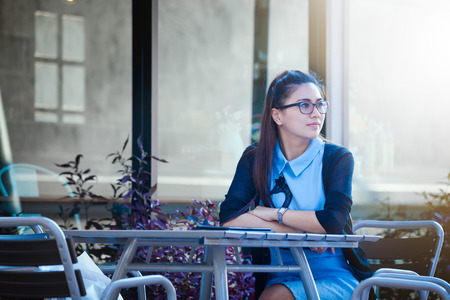 Young woman sitting in coffee shopの写真素材
