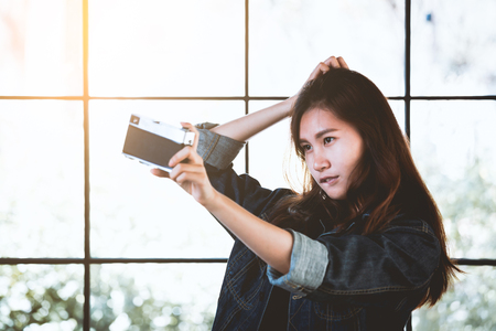 Asia beauty stylish woman with a retro camera in free timeの写真素材