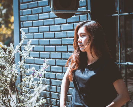 Asia youth teenage girl absurd posing on wall background. Lifestyle people concept in cafe.