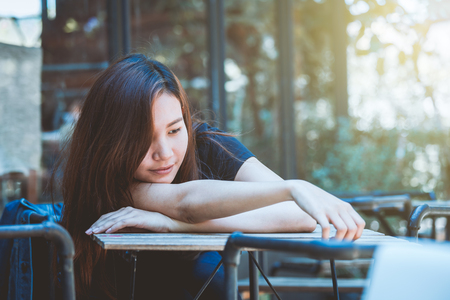 Asia youth teenager sitting depression on chair. Lifestyle people concept in cafe.の写真素材