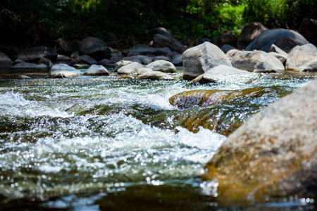 Close-up of stone with water rapids on the river, at travel attractionの写真素材