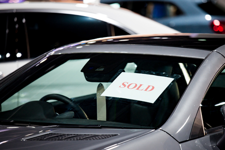 Selective focus sold label of car in parking at show roomの写真素材