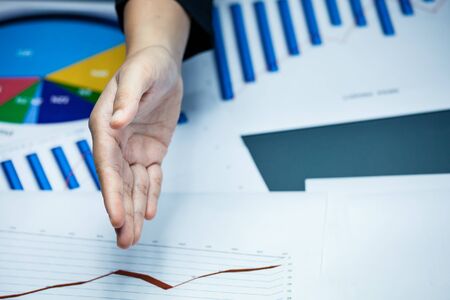 Closeup of businessperson is holding the hand shaking above the working deskの写真素材
