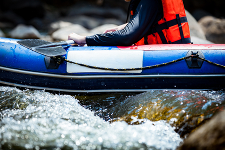 Focus some part of young person are rafting in river with empty space for advertisingの写真素材