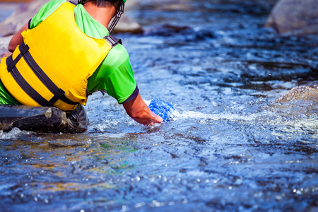 Close-up hand of young men is rafting on the river, extreme and fun sport at tourist attractionの写真素材
